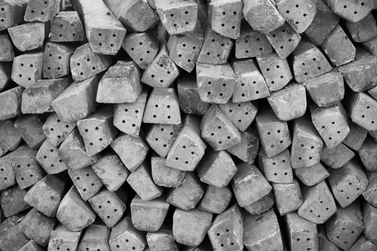 Monochrome image of stacked concrete blocks showing textures and patterns.